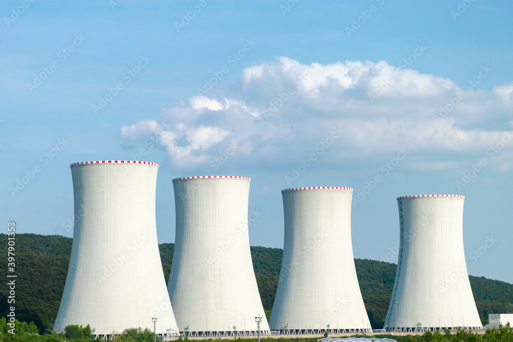 Nuclear power plant. Cooling towers on the background of blue sky and mountains Nuclear power plant. Cooling towers on the background of blue sky and mountains