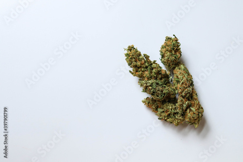 Medical marijuana flower buds placed on a white