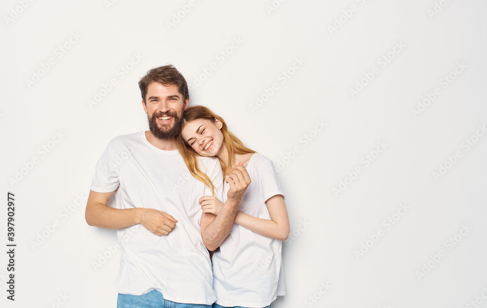 Couple in love man and woman light background fun emotions the same clothes