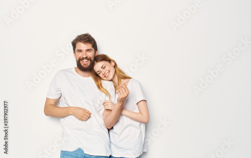 Couple in love man and woman light background fun emotions the same clothes