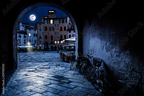 The Square of the Amphitheatre in Lucca, Itlay at Night with Full Moon photo
