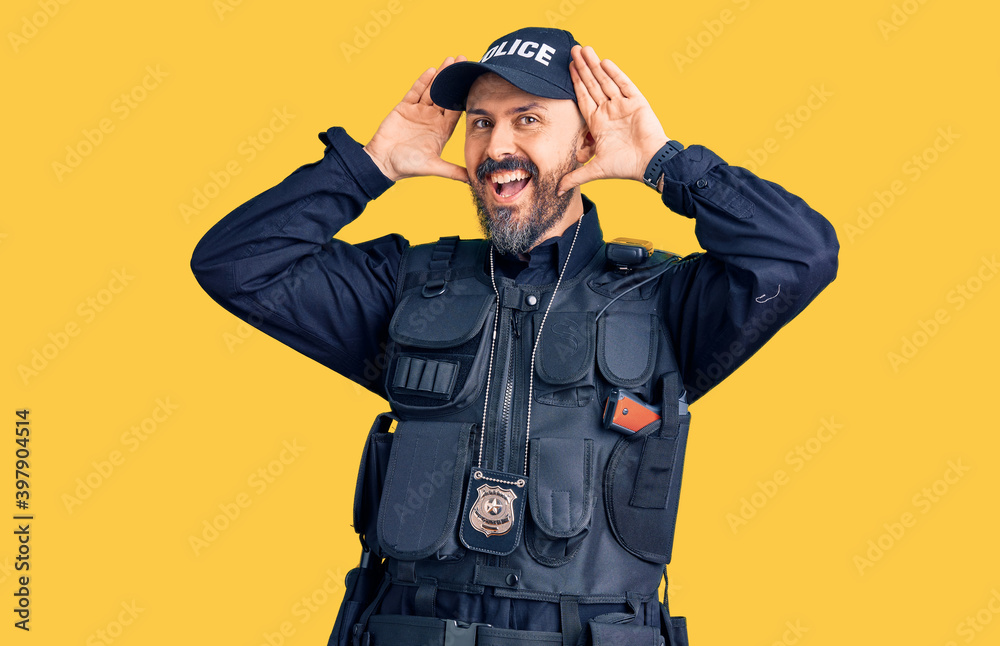 Young handsome man wearing police uniform smiling cheerful playing peek a boo with hands showing face. surprised and exited Young handsome man wearing police uniform smiling cheerful playing peek a boo with hands showing face. surprised and exited