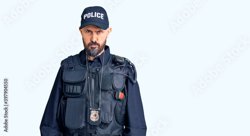 Young handsome man wearing police uniform depressed and worry for distress, crying angry and afraid. sad expression.