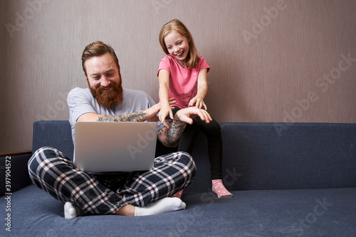 Daughter using laptop with her father