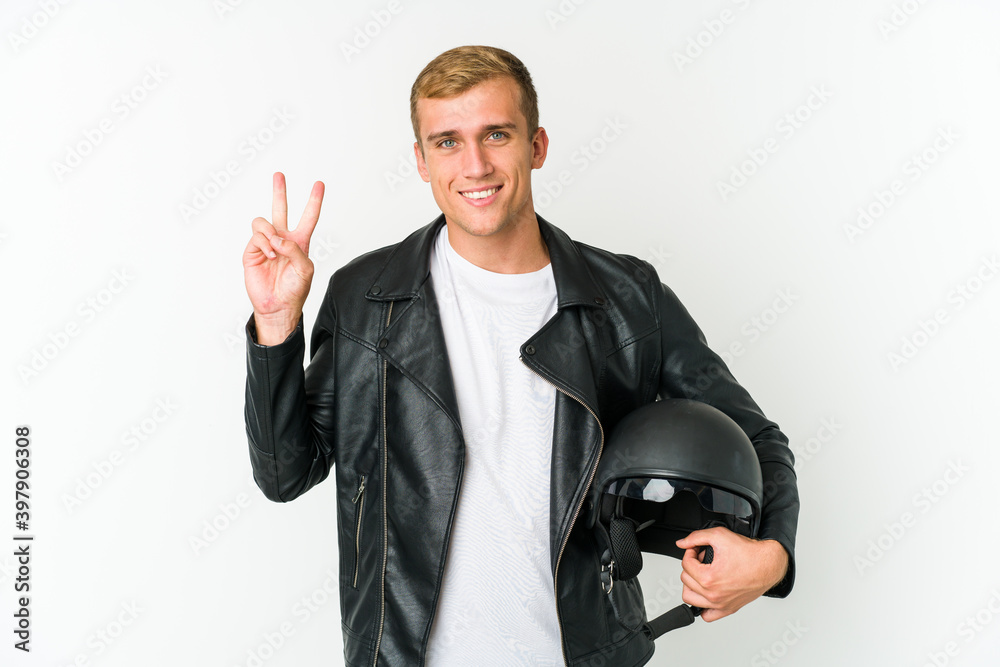 Young caucasian man holding a motorbike helmet isolated on white background Young caucasian man holding a motorbike helmet isolated on white background