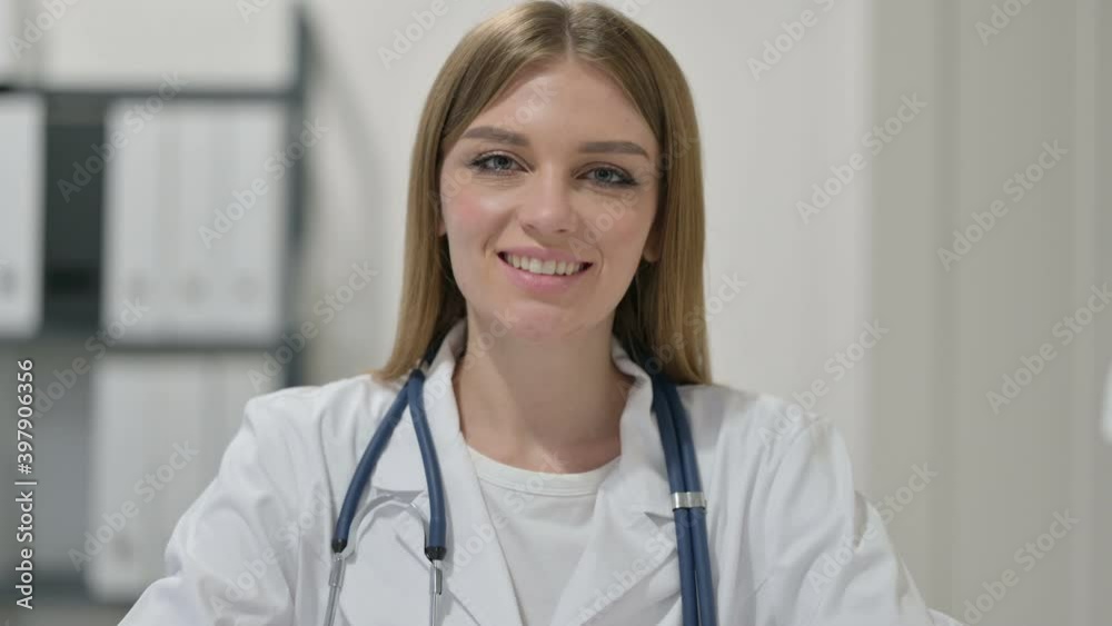 Portrait of Young Female Doctor Smiling at Camera Portrait of Young Female Doctor Smiling at Camera