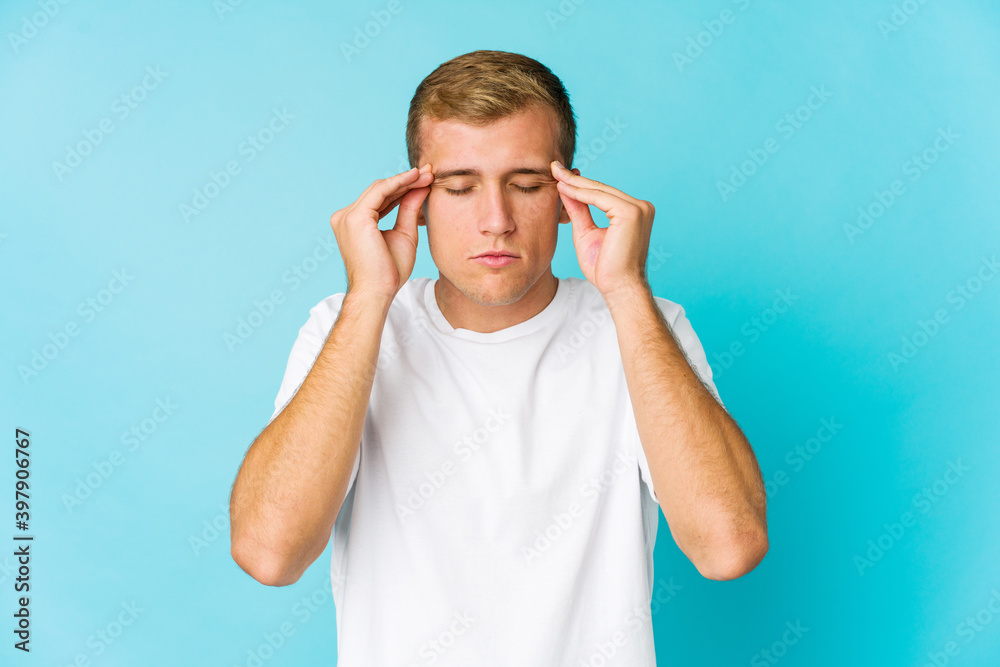 Young caucasian handsome man touching temples and having headache. Young caucasian handsome man touching temples and having headache.