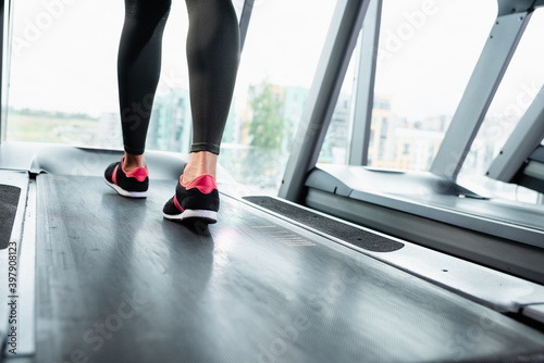 cropped view of sportswoman in leggings and sneakers training on treadmill © LIGHTFIELD STUDIOS