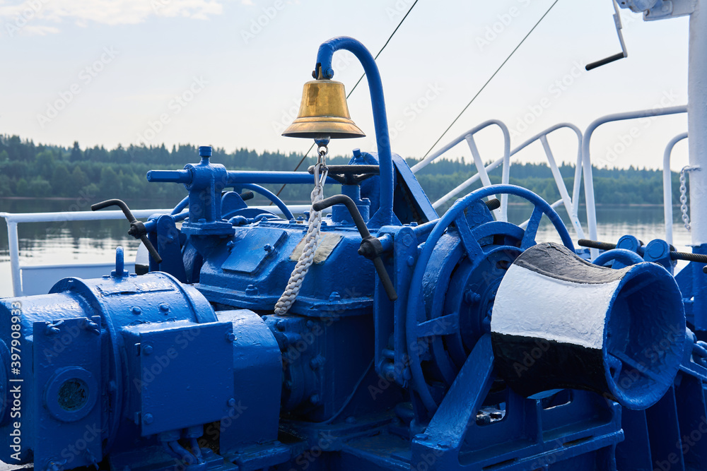 bell, capstan and other mechanisms, painted blue, on the foredeck of the river ship, close-up bell, capstan and other mechanisms, painted blue, on the foredeck of the river ship, close-up
