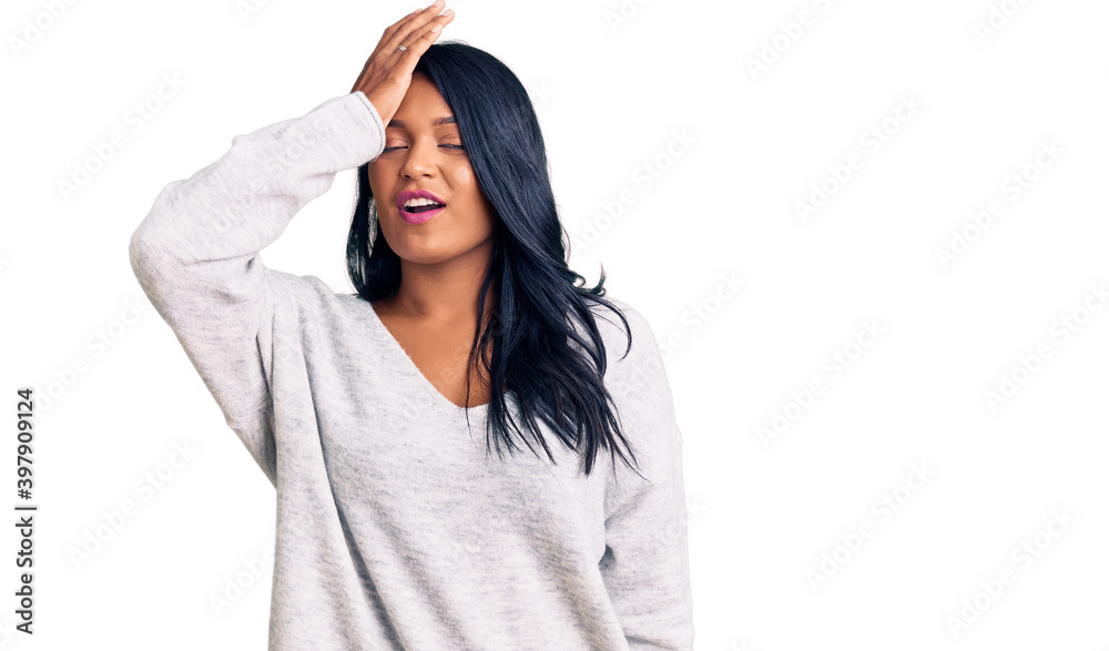 Hispanic woman with long hair wearing casual clothes surprised with hand on head for mistake, remember error. forgot, bad memory concept. Hispanic woman with long hair wearing casual clothes surprised with hand on head for mistake, remember error. forgot, bad memory concept.
