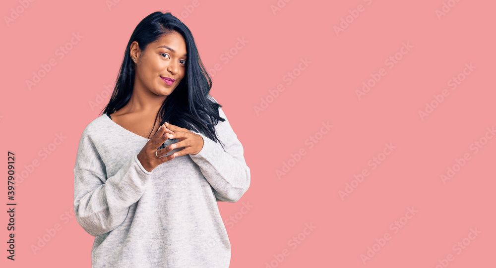 Hispanic woman with long hair wearing casual clothes hands together and fingers crossed smiling relaxed and cheerful. success and optimistic