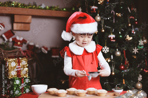 young girl preparing mince pie for celebrating  Christmas party © M-image