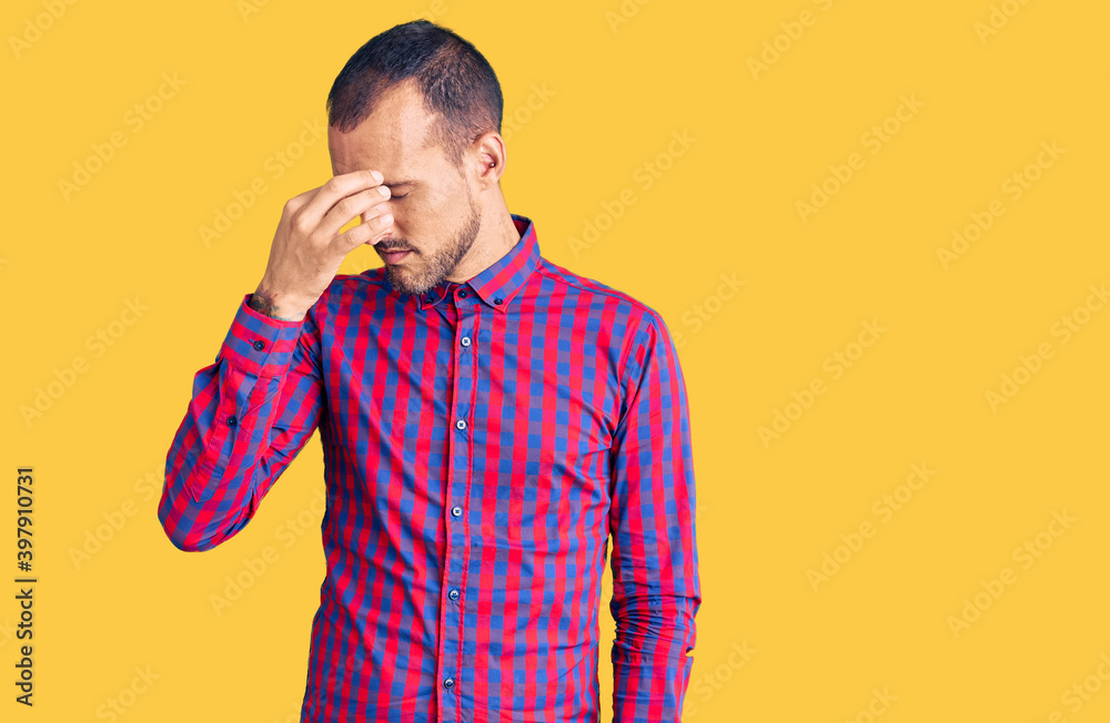 Young handsome man wearing casual clothes tired rubbing nose and eyes feeling fatigue and headache. stress and frustration concept. Young handsome man wearing casual clothes tired rubbing nose and eyes feeling fatigue and headache. stress and frustration concept.