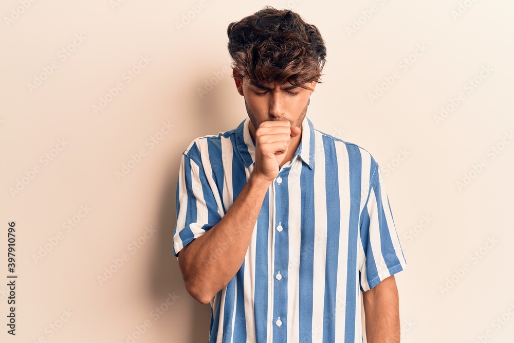 Young hispanic man wearing casual clothes feeling unwell and coughing as symptom for cold or bronchitis. health care concept. Young hispanic man wearing casual clothes feeling unwell and coughing as symptom for cold or bronchitis. health care concept.