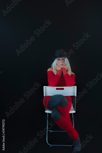 Mature Woman sitting in a backward chair