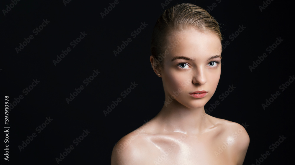 Fashionable woman with perfect face and clean skin on black background.