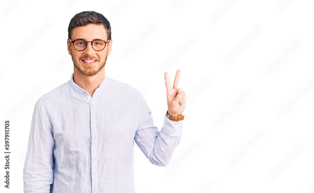 Handsome young man with bear wearing elegant business shirt and glasses smiling looking to the camera showing fingers doing victory sign. number two. Handsome young man with bear wearing elegant business shirt and glasses smiling looking to the camera showing fingers doing victory sign. number two.