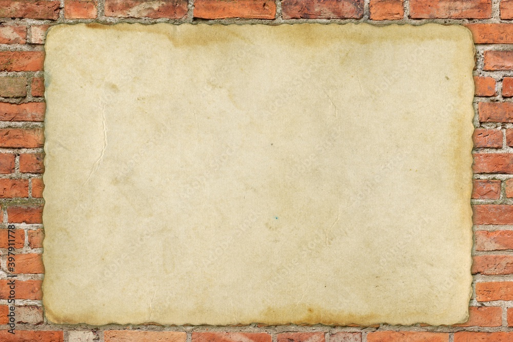 old sheet of paper on old red brick wall 