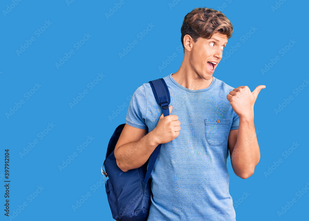 Young handsome man holding student backpack pointing thumb up to the side smiling happy with open mouth Young handsome man holding student backpack pointing thumb up to the side smiling happy with open mouth