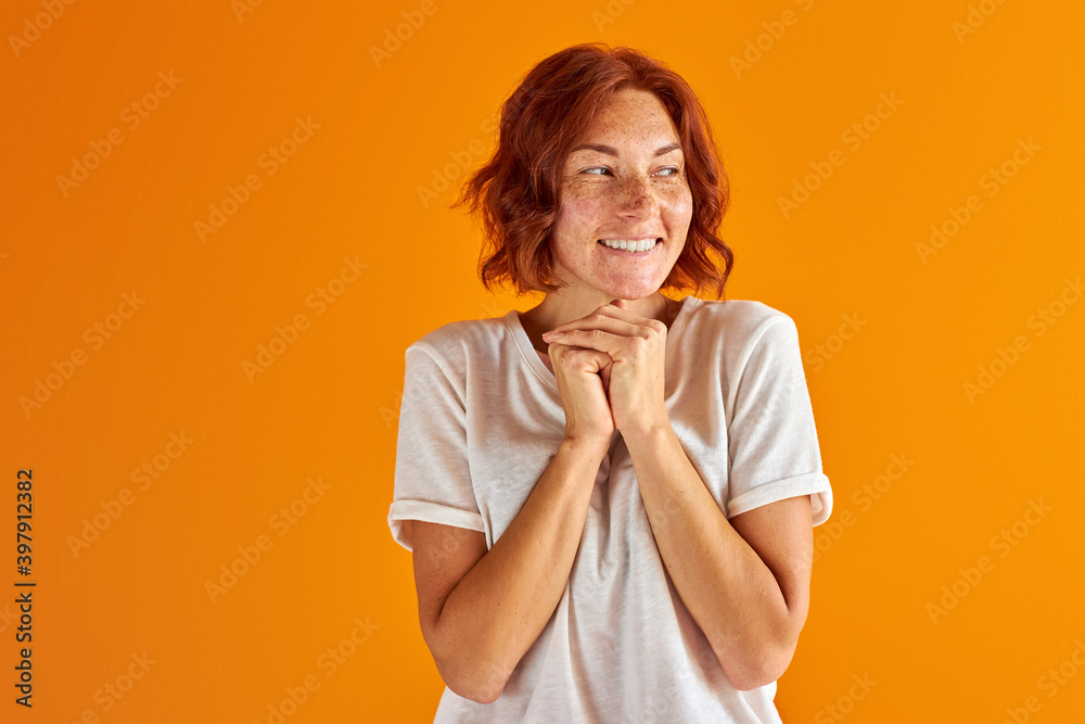 excited lady in casual wear stand in contemplation, dreaming, thinking about something she wish. isolated orange background excited lady in casual wear stand in contemplation, dreaming, thinking about something she wish. isolated orange background