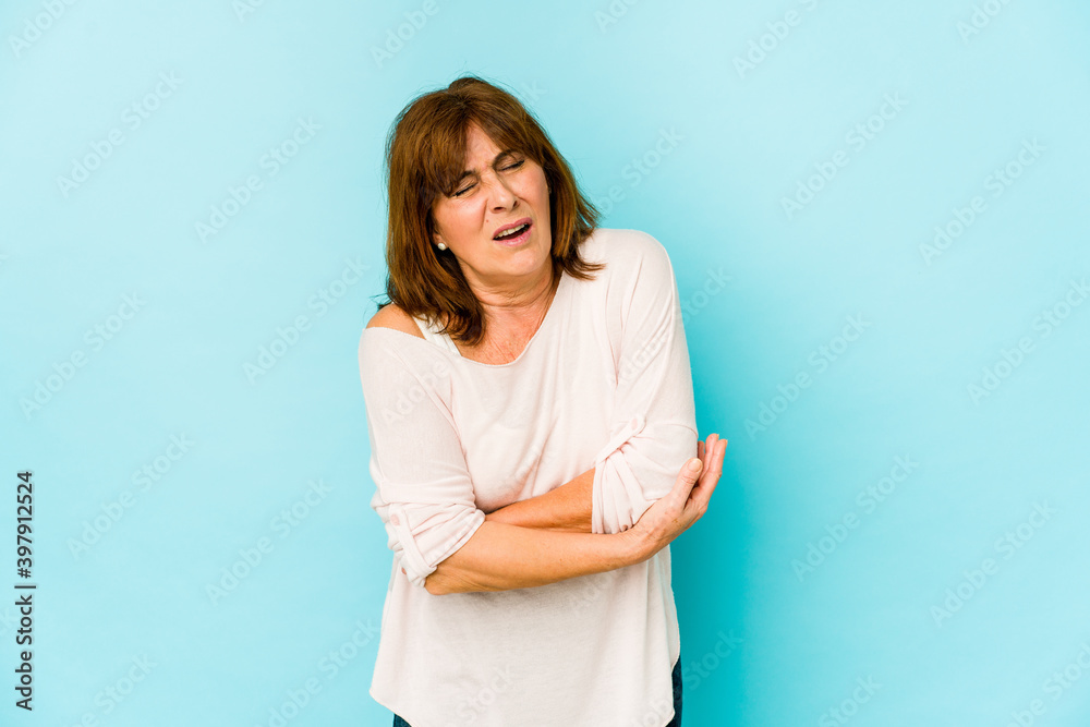 Senior caucasian woman isolated massaging elbow, suffering after a bad movement. Senior caucasian woman isolated massaging elbow, suffering after a bad movement.