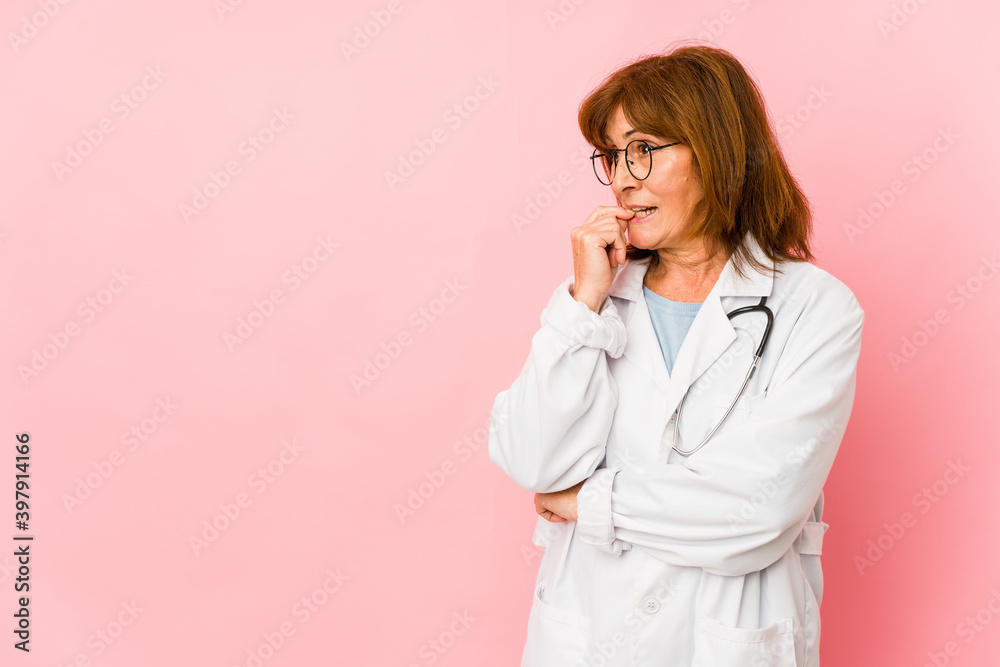 Middle age caucasian doctor woman isolated relaxed thinking about something looking at a copy space. Middle age caucasian doctor woman isolated relaxed thinking about something looking at a copy space.