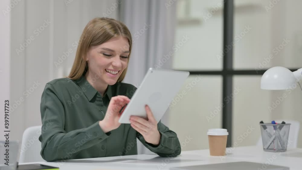 Successful Woman Celebrating on Tablet at Work Successful Woman Celebrating on Tablet at Work