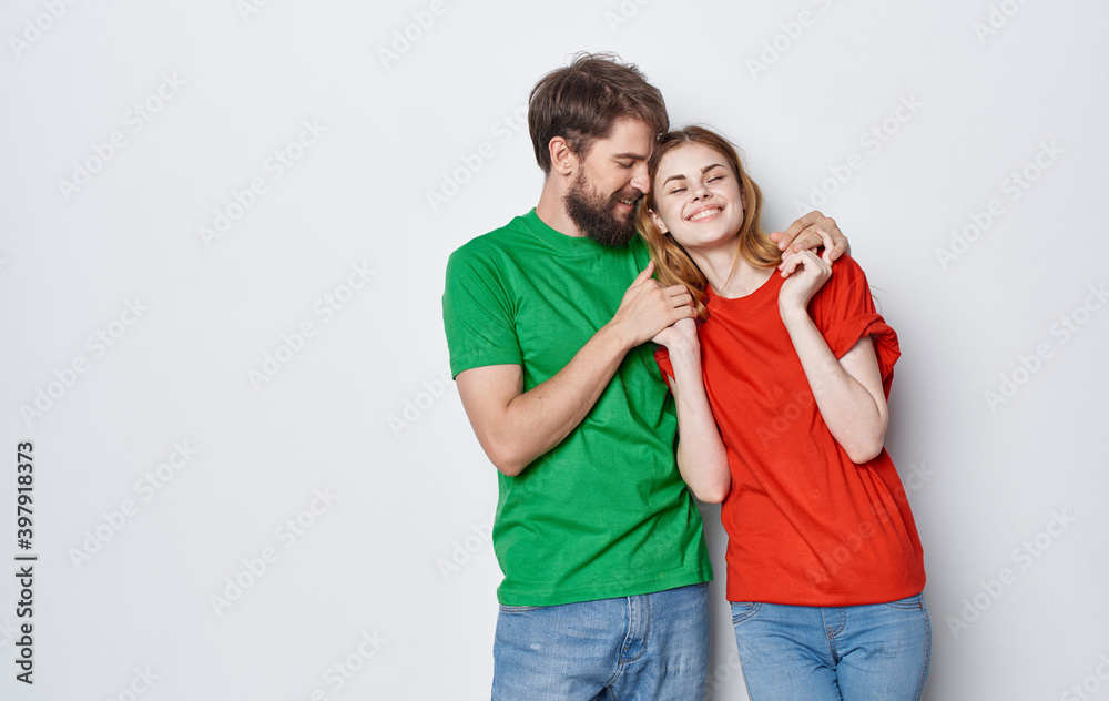 young cheerful couple in multicolored t-shirts communication emotions friendship studio young cheerful couple in multicolored t-shirts communication emotions friendship studio