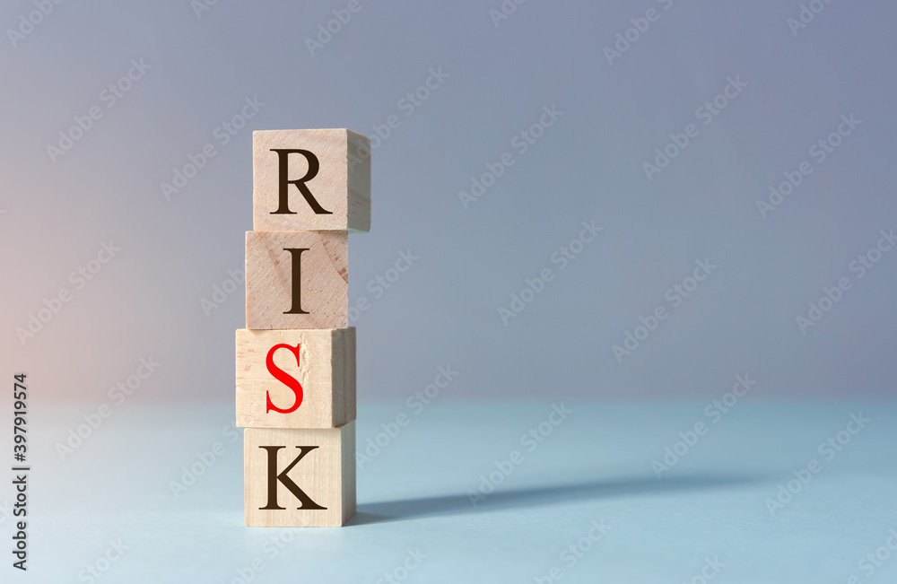 Stack of wooden cubes with risk word and copy space. Concept of risk management. Selective focus with depth of field. Stack of wooden cubes with risk word and copy space. Concept of risk management. Selective focus with depth of field.