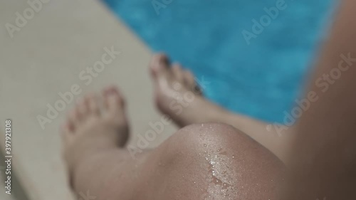 person on the pool - water reflections on skin - water drops on skin
