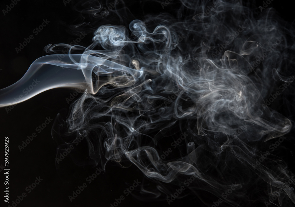 Abstract puffs of smoke on a black background.