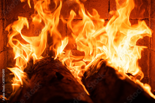 Glowing fire in a huge stone fireplace. Fire flame texture. Abstract burning blaze flames for banner background. Blaze fire for banner. Burning concept.