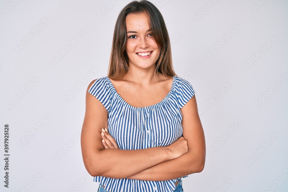 Beautiful caucasian woman wearing casual striped shirt happy face smiling with crossed arms looking at the camera. positive person. Beautiful caucasian woman wearing casual striped shirt happy face smiling with crossed arms looking at the camera. positive person.