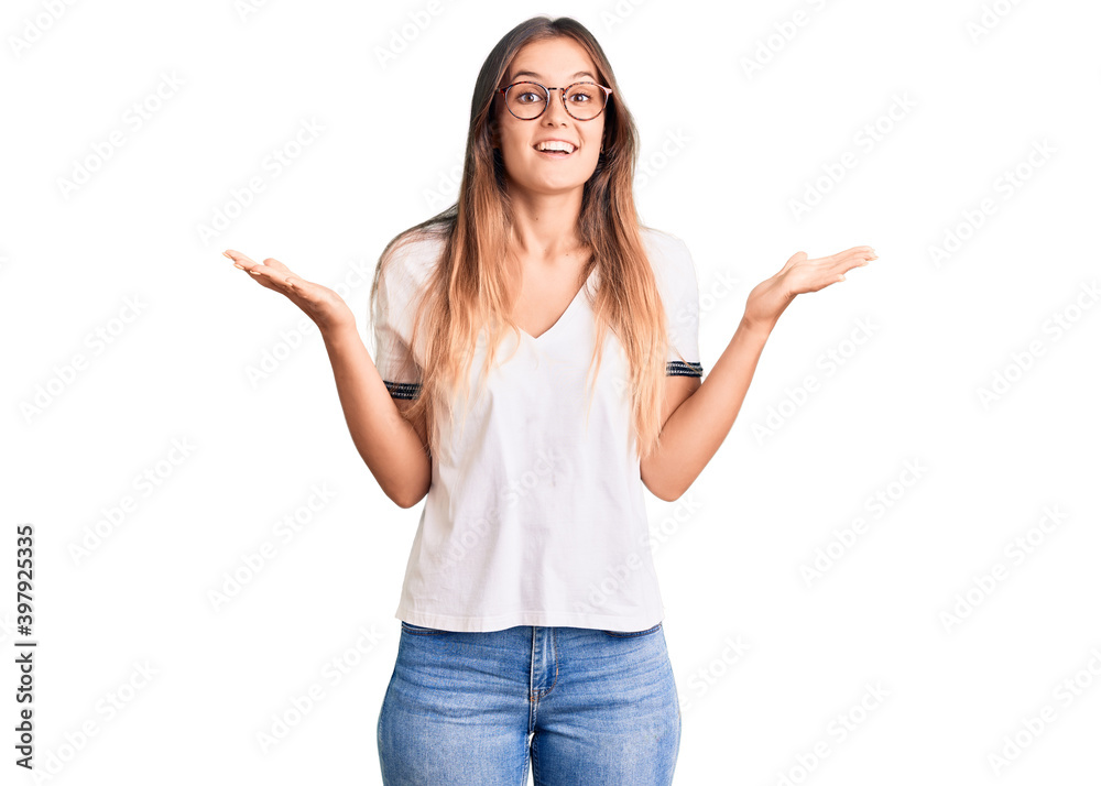 Beautiful caucasian woman wearing casual clothes and glasses scared and amazed with open mouth for surprise, disbelief face Beautiful caucasian woman wearing casual clothes and glasses scared and amazed with open mouth for surprise, disbelief face