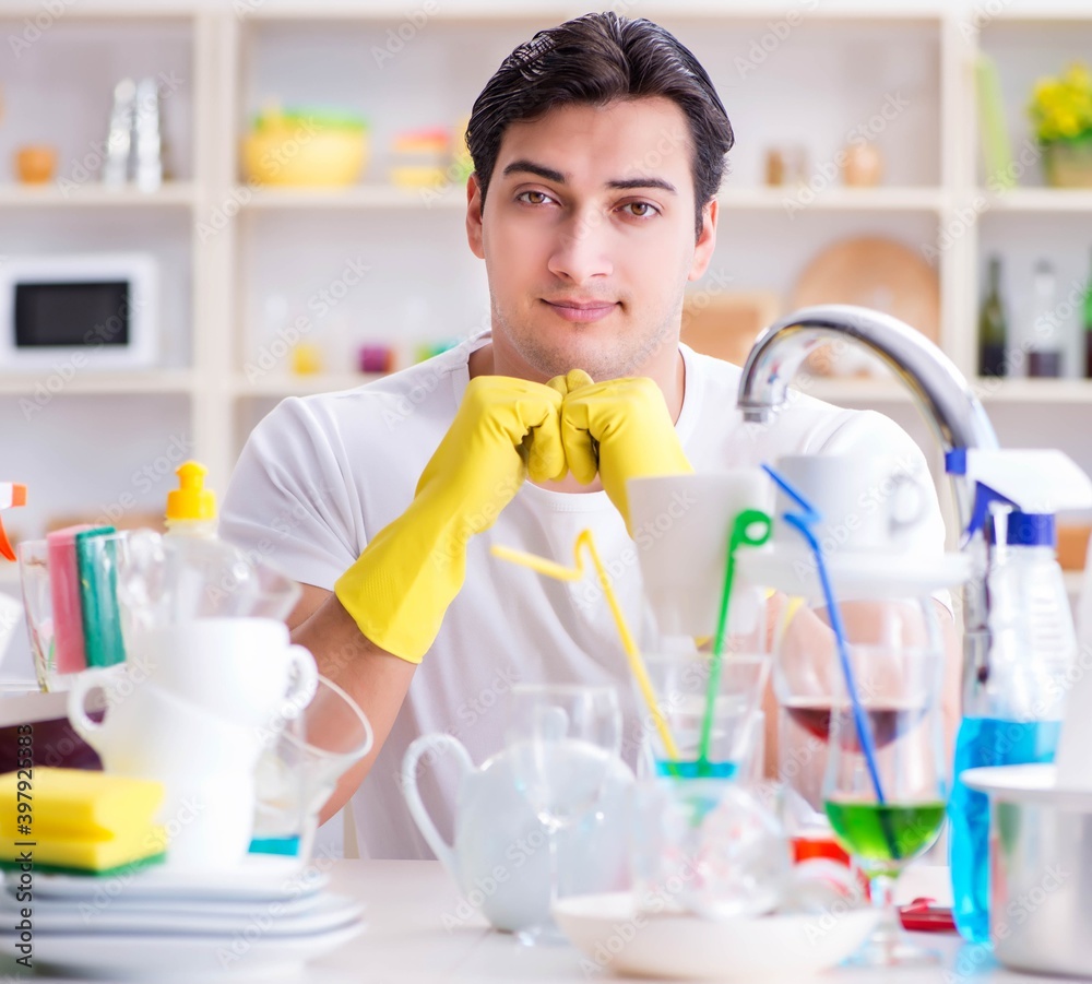 Man enjoying dish washing chores at home Man enjoying dish washing chores at home
