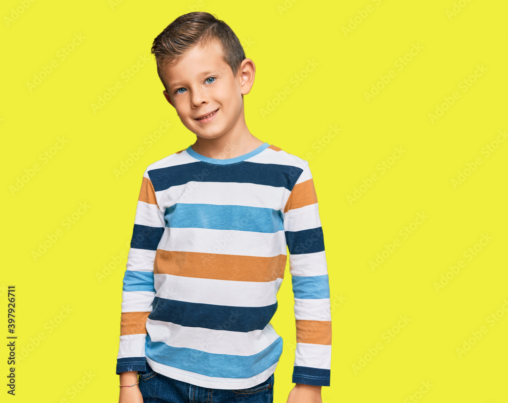 Adorable caucasian kid wearing casual clothes looking positive and happy standing and smiling with a confident smile showing teeth Adorable caucasian kid wearing casual clothes looking positive and happy standing and smiling with a confident smile showing teeth