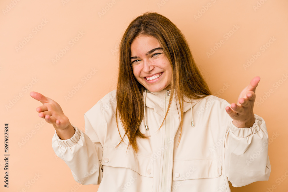 Young skinny caucasian teenager girl showing a welcome expression. Young skinny caucasian teenager girl showing a welcome expression.