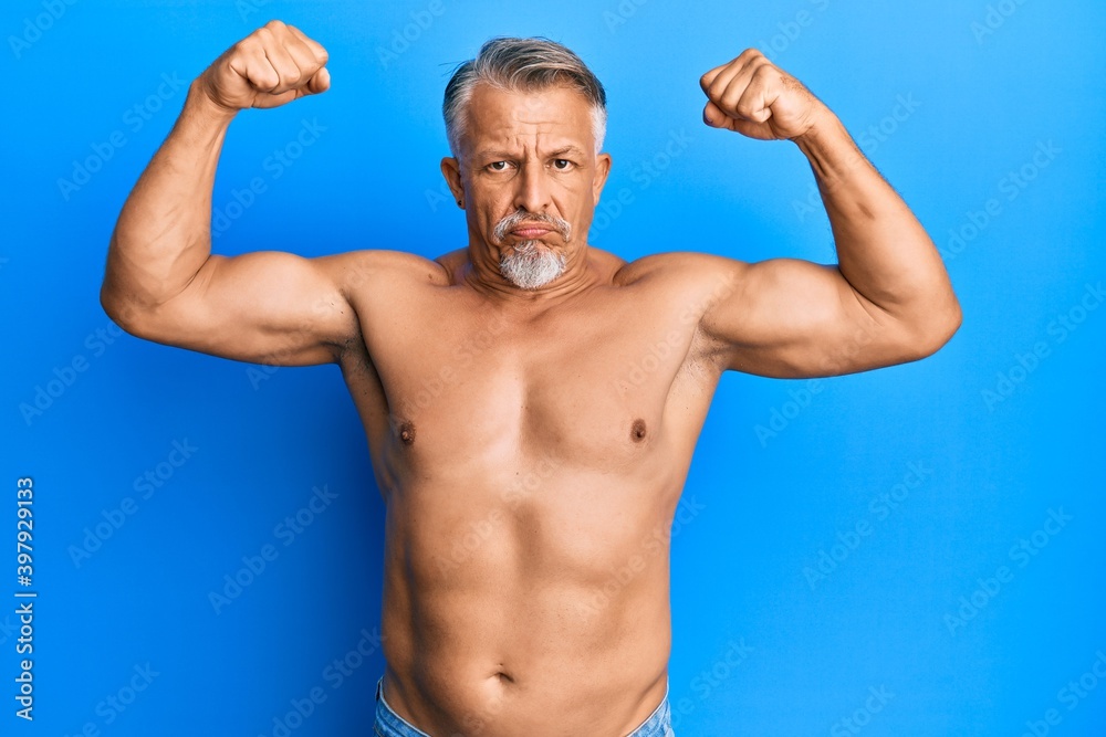 Middle age grey-haired man standing shirtless doing fitness gesture depressed and worry for distress, crying angry and afraid. sad expression.