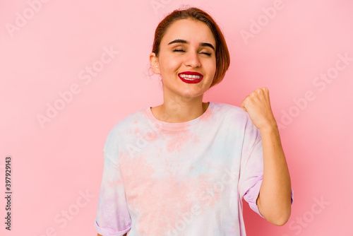 Young arab mixed race woman celebrating a victory, passion and enthusiasm, happy expression.