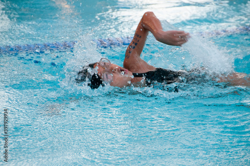 Female child swimming freestyle at a swim meet © Rodney