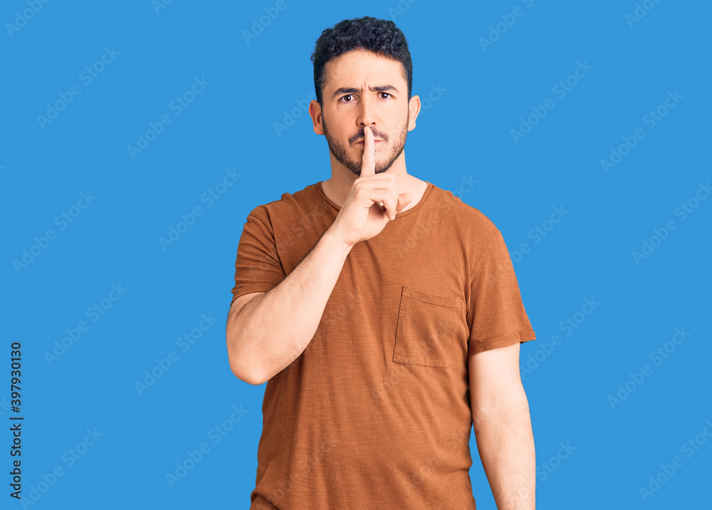 Young hispanic man wearing casual clothes asking to be quiet with finger on lips. silence and secret concept. Young hispanic man wearing casual clothes asking to be quiet with finger on lips. silence and secret concept.