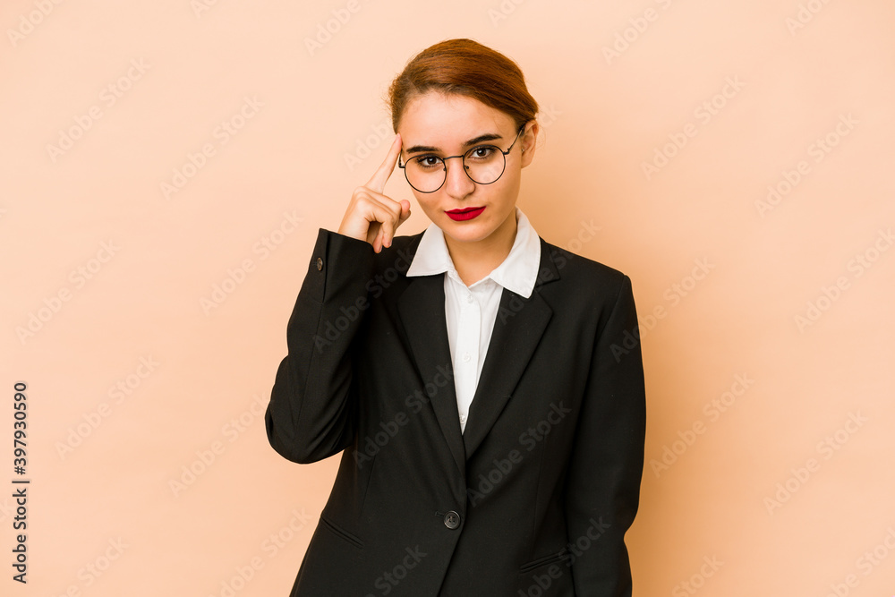 Young skinny caucasian business woman isolated pointing temple with finger, thinking, focused on a task. Young skinny caucasian business woman isolated pointing temple with finger, thinking, focused on a task.