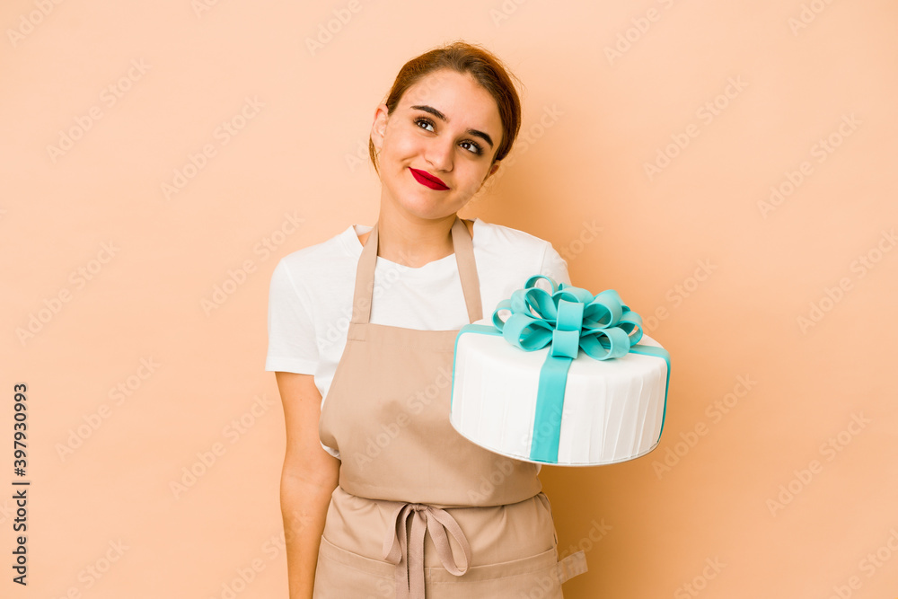 Young skinny arab pastry chef woman dreaming of achieving goals and purposes Young skinny arab pastry chef woman dreaming of achieving goals and purposes