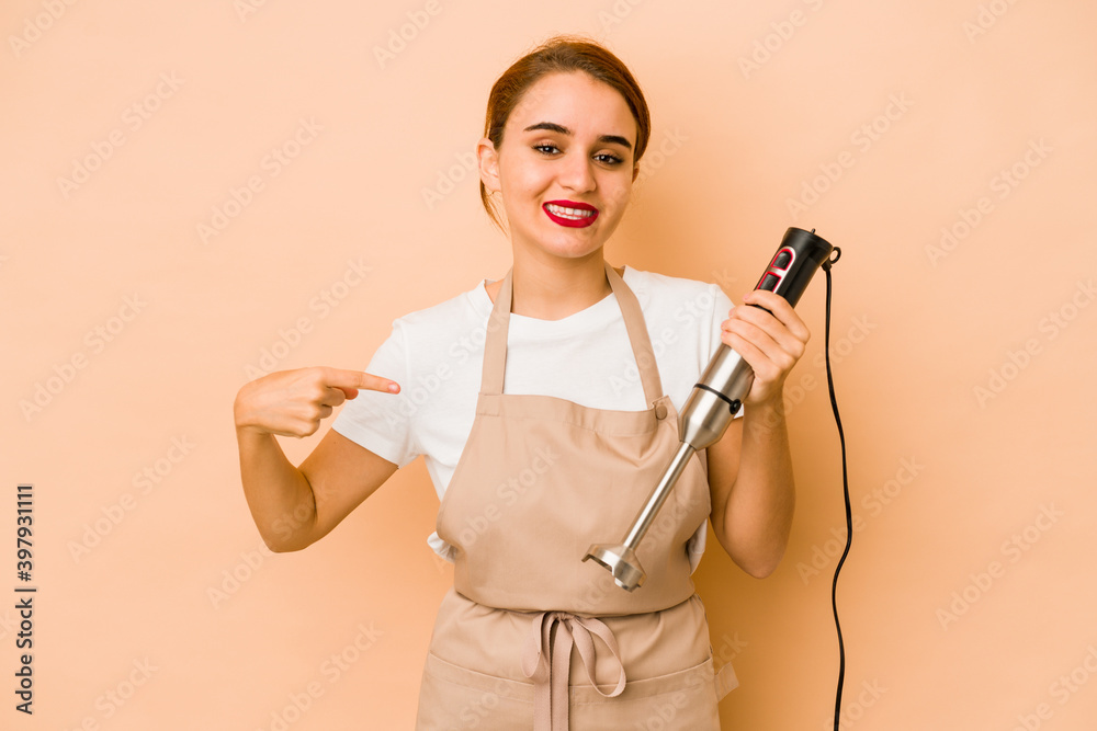 Young skinny arab cook woman person pointing by hand to a shirt copy space, proud and confident Young skinny arab cook woman person pointing by hand to a shirt copy space, proud and confident