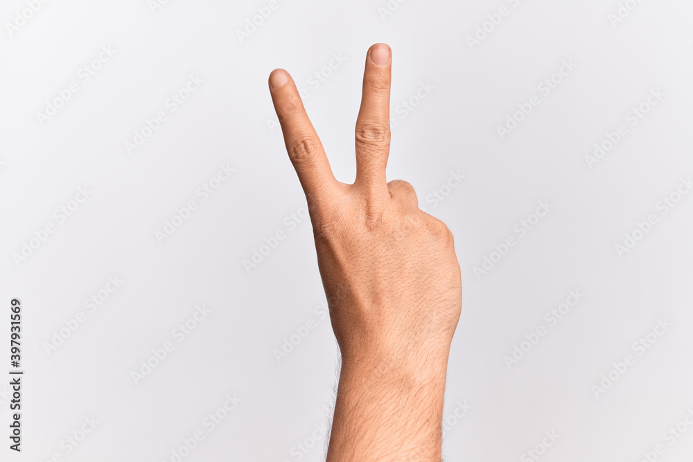 Hand of caucasian young man showing fingers over isolated white background counting number 2 showing two fingers, gesturing victory and winner symbol Hand of caucasian young man showing fingers over isolated white background counting number 2 showing two fingers, gesturing victory and winner symbol