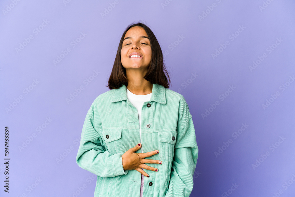 Young mixed race woman touches tummy, smiles gently, eating and satisfaction concept. Young mixed race woman touches tummy, smiles gently, eating and satisfaction concept.