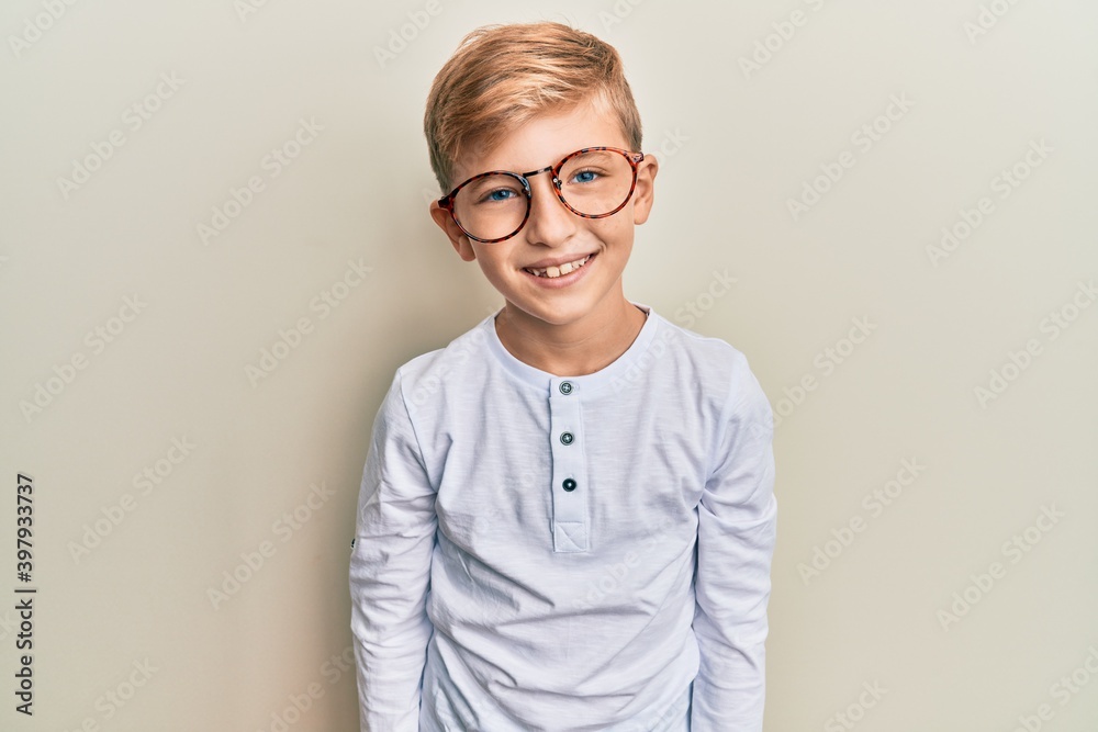 Little caucasian boy kid wearing casual clothes and glasses with a happy and cool smile on face. lucky person. Little caucasian boy kid wearing casual clothes and glasses with a happy and cool smile on face. lucky person.