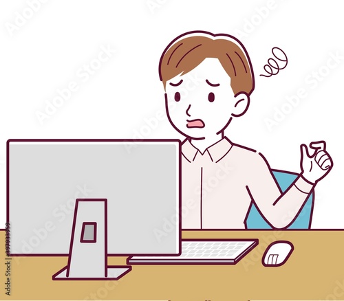 A man in a pink shirt using a computer
