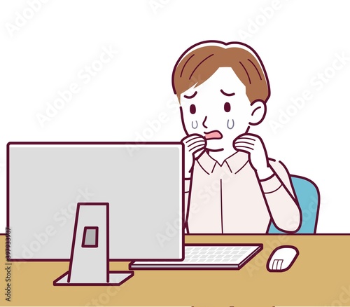 A man in a pink shirt using a computer