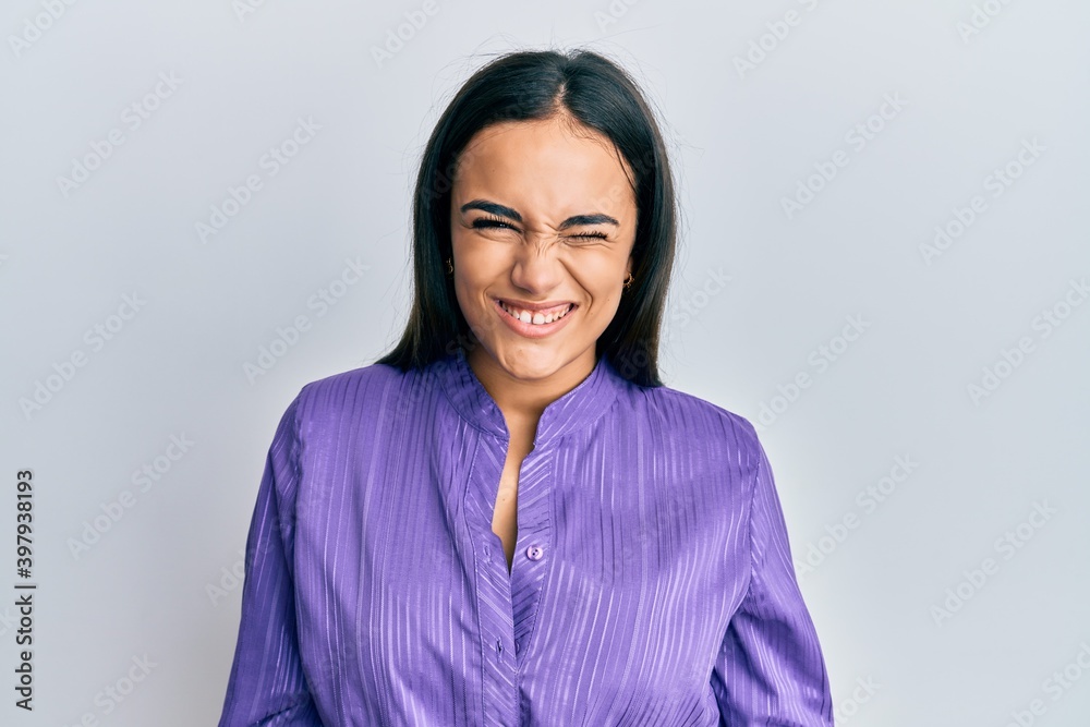 Young brunette woman wearing casual clothes winking looking at the camera with sexy expression, cheerful and happy face.